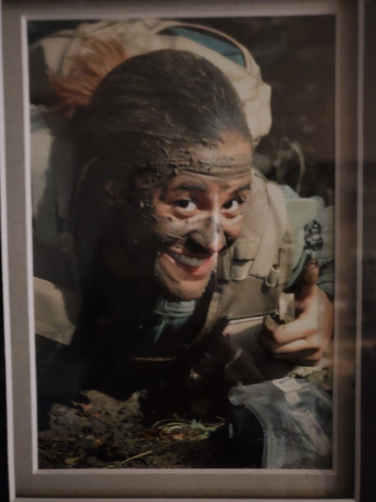 Woman in military camouflage smiling