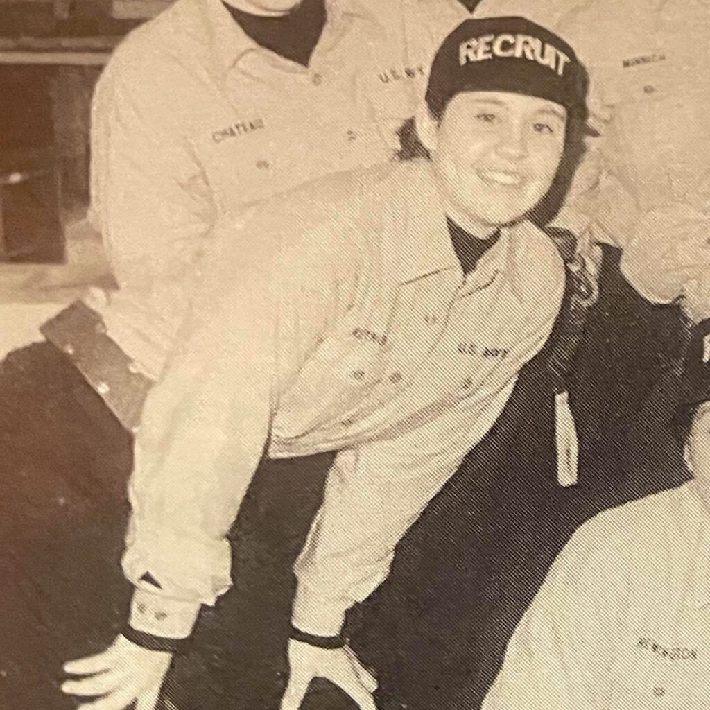 closeup of a young woman posing for a group photo during Navy bootcamp