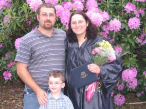 A woman and her family at her college graduation