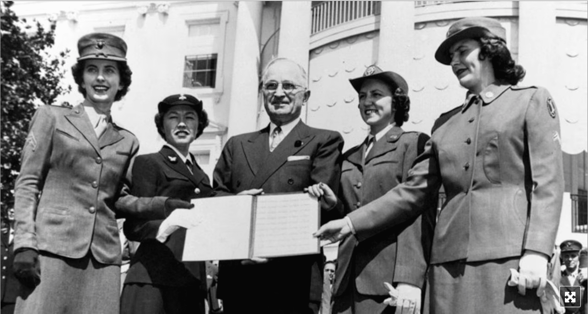 A photo of President Truman and four military women in 1948, holding the Armed Forces Integration Act he signed into law.