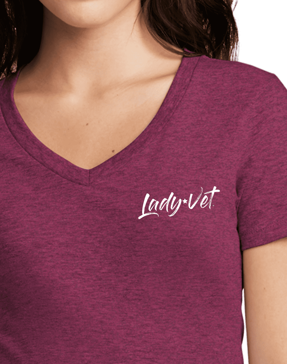 A close up of a woman in a raspberry color Lady Vet V-neck tee
